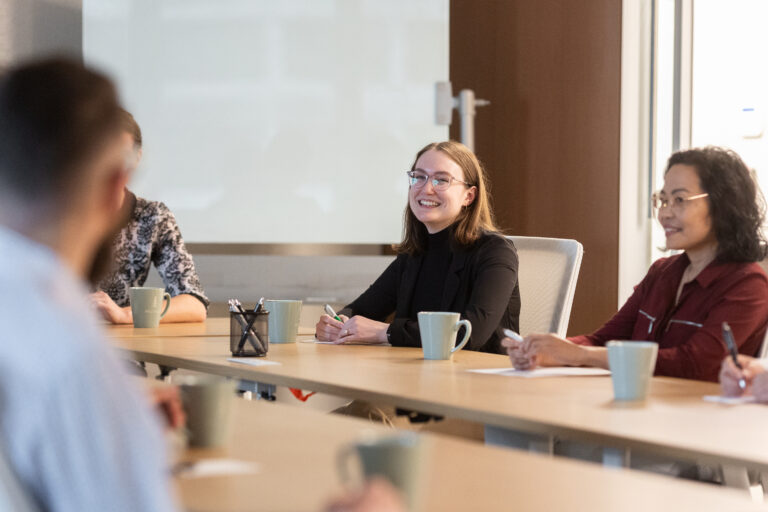Welch LLP staff sitting at a table in the middle of a meeting